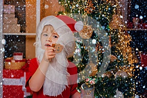 Merry Christmas and happy new year. Thanksgiving day and Christmas. Happy Santa Claus - cute boy child eating a cookie