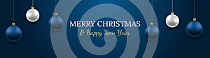 Merry Christmas and Happy New Year vector banner. Realistic rose gold and blue baubles, snowflakes hanging on dark blue background