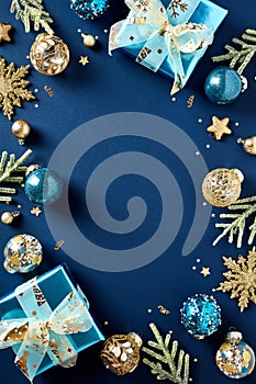 Merry Christmas and Happy New Year vertical banner template. Frame of luxury gifts, golden balls and decorations, fir branches on