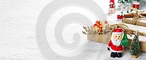 Merry Christmas and Happy new year web banner. Santa Clause toys with Natural Christmas gift box with pine tree and Christmas toys