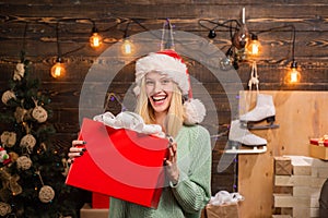 Merry Christmas and Happy New Year. Young woman with christmas present boxes in front of christmas tree. Home Holiday