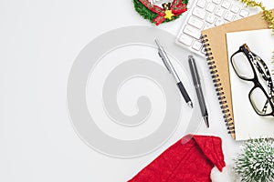 Merry Christmas and Happy new years office work space desktop concept. Flat lay top view with keyboard, red hat, glasses and