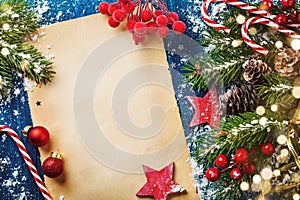 Merry Christmas holiday card or banner with snowy fir branches, cones and festive decorations. Magic bokeh lights