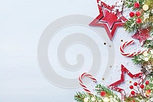 Merry Christmas holiday card or banner with snowy fir branches, red stars and festive decorations. Magic bokeh lights