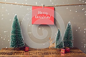 Merry Christmas holiday greeting card handing on wall with pine tree