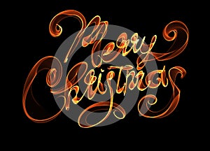 Merry Christmas isolated text lettering written with flame fire light on black background. Orange red color