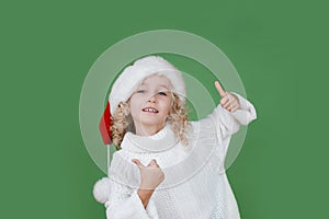 Merry Christmas Little girl in Santa hat on bright green vivid color background