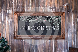 Merry Christmas on message note with wooden background