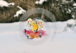 .Merry Christmas mouse yellow in pink dress-a toy in the snow. Christmas card.