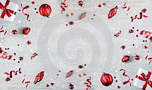 Merry Christmas and New Year background. Xmas holiday card made of flying decorations, fir branches, red balls, snowflakes,
