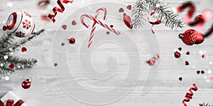 Merry Christmas and New Year background. Xmas holiday card made of flying decorations, fir branches, red balls, snowflakes,