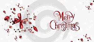 Merry Christmas and New Year text on white background with gift boxes, ribbons, red decoration, bokeh, sparkles and confetti. Xmas