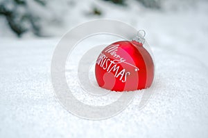 Merry Christmas .Red Christmas ball i in the snow in a snowy forest.Holiday themed wallpaper. Winter holidays.Winter