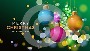 Merry Christmas sale banner with colorful baubles sparkle in blur bokeh effect green background