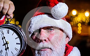 Merry Christmas. Santa Claus with alarm clock. Time to celebrate. New year party. Winter holidays.