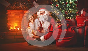 Merry Christmas! santa claus and child girl at night at the Chr