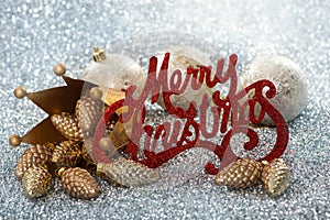 Merry christmas sign with crown and pinecone as christmas decoration