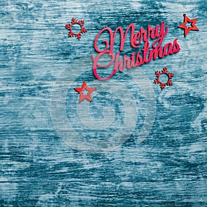 Merry Christmas sign and handmade fir toys, view from top, blue wooden background, Xmas greeting card