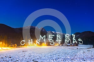 Merry Christmas sign under Tatra mountains at night