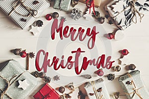 Merry christmas text, seasonal greetings card sign. flat lay. pr