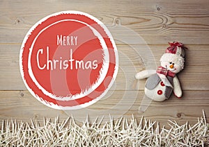 Merry Christmas text with snowman on wood