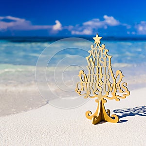 Merry Christmas text on the tropical beach