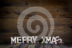 Merry christmas text on wooden old background.