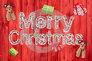 Merry christmas text on wooden red background with reindeer and