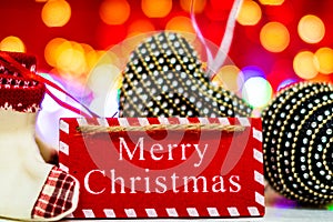 Merry Christmas text wooden sign, decorations and ornaments in a colorful Christmas composition