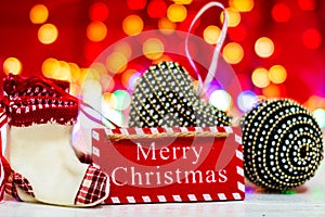 Merry Christmas text wooden sign, decorations and ornaments in a colorful Christmas composition