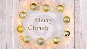 Merry Christmas text write in frame with Christmas ornaments and blinking lights. Stop motion
