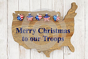 Merry Christmas to our troops greeting with stars on weathered wood USA map