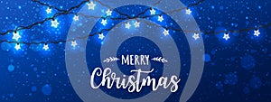 Merry Christmas Typographical on blue background with Xmas decorations glowing white garlands, light, stars