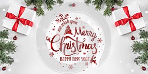 Merry Christmas Typographical on white background with gift boxes, fir branches, red decoration.