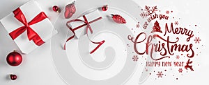 Merry Christmas Typographical on white background with gift boxes and red decoration.