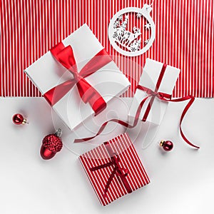 Merry Christmas Typographical on white and red paper background with gift boxes, red decoration.