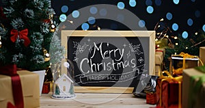 Merry Christmas Typography on Blackboard Between Christmas Decor