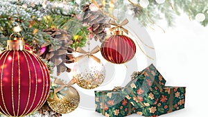 Merry Christmas white red  gold ball and gift box with  greetings card on colorful pine tree branch  snow flakes  banner