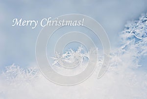 Merry Christmas white text with light winter snowflakes background