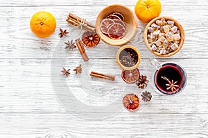 Merry christmas in winter evening with warm drink. Hot mulled wine or grog with fruits and spices on light background
