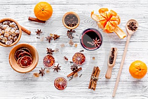 Merry christmas in winter evening with warm drink. Hot mulled wine or grog with fruits and spices on light background