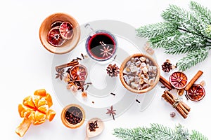 Merry christmas in winter evening with warm drink. Hot mulled wine or grog with fruits and spices on white background