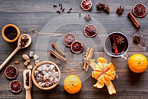 Merry christmas in winter evening with warm drink. Hot mulled wine or grog with fruits and spices on wooden background