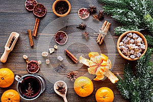 Merry christmas in winter evening with warm drink. Hot mulled wine or grog with fruits and spices on wooden background