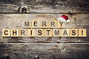 Merry Christmas. Words made up of alphabet on wooden cubes. Wooden background. Christmas background.