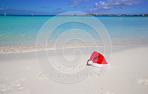 Merry Christmas written on tropical beach white