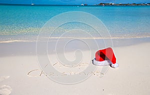 Merry Christmas written on tropical beach white