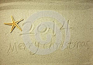 Merry Christmas written on tropical beach white sand