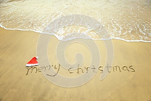 Merry Christmas written on tropical beach white sand