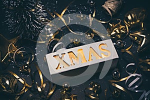 Merry christmas,xmas and celebration concepts with xmas lightbox text and ornament in golden color on dark